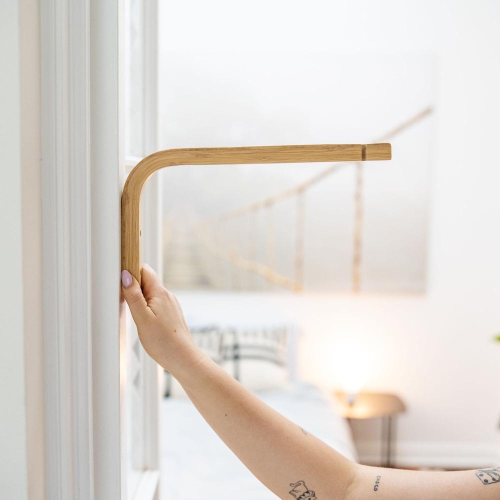 sun_bulb_bamboo_wall_mount_being_held_against_the_wall